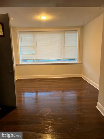 a view of a room with wooden floor and windows