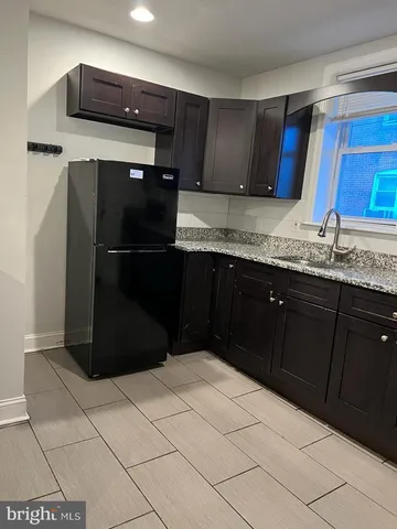 a kitchen with a refrigerator and a sink