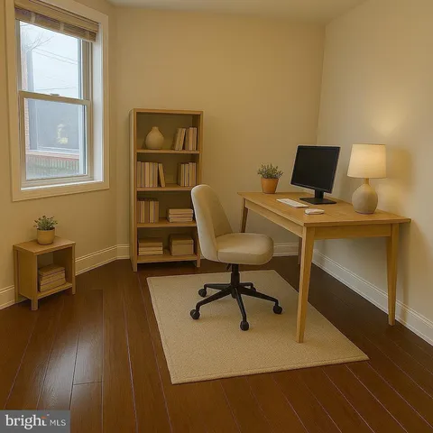 a work room with furniture wooden floor and a window