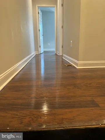 a view of room with wooden floor