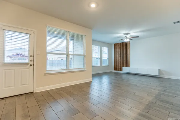 a view of an empty room with glass door and a window