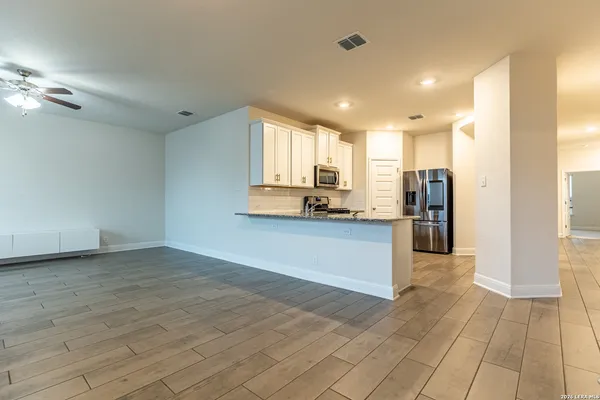 a view of kitchen with refrigerator and window