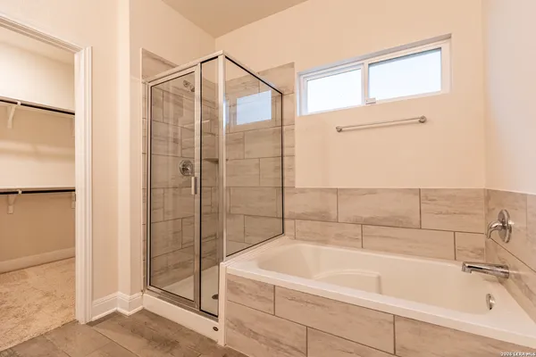 a bathroom with a tub and shower