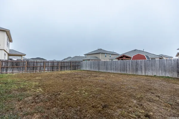 a view of residential houses with a yard