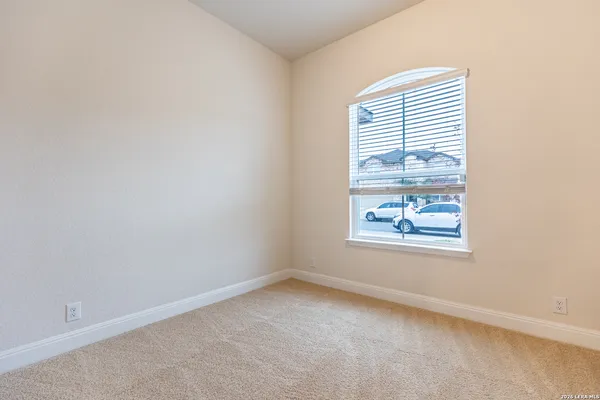 an empty room with windows and wall painting
