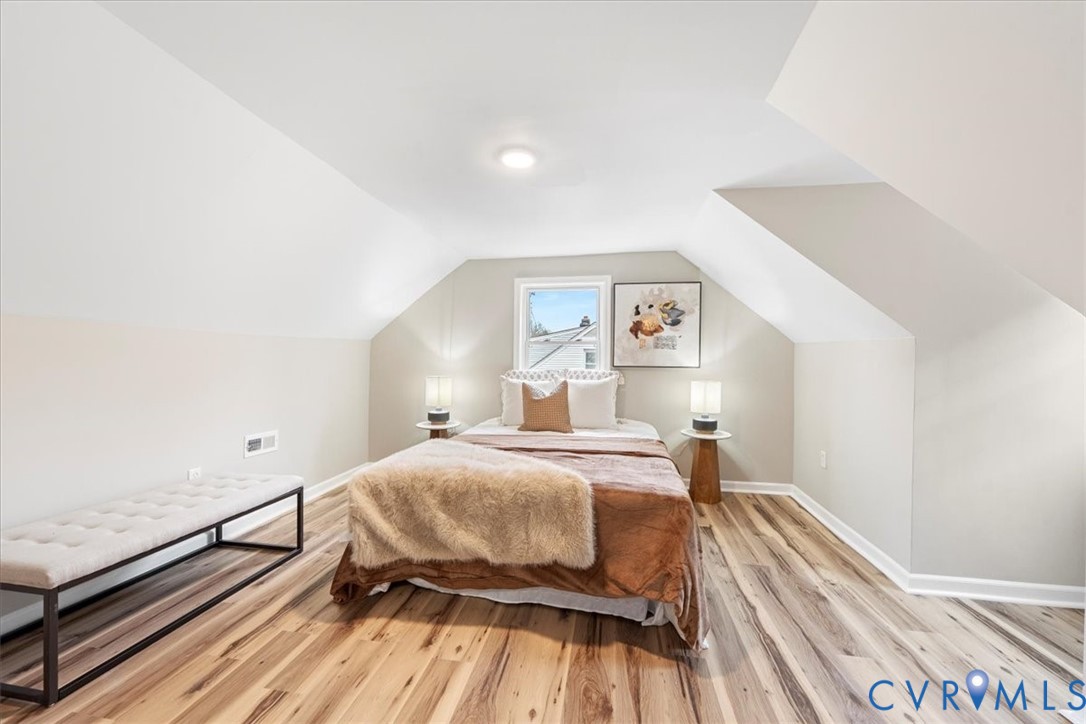 1989 Cox Road Blackstone, VA 23824 - Photo 23 of 44 Bedroom featuring lofted ceiling and light wood-ty