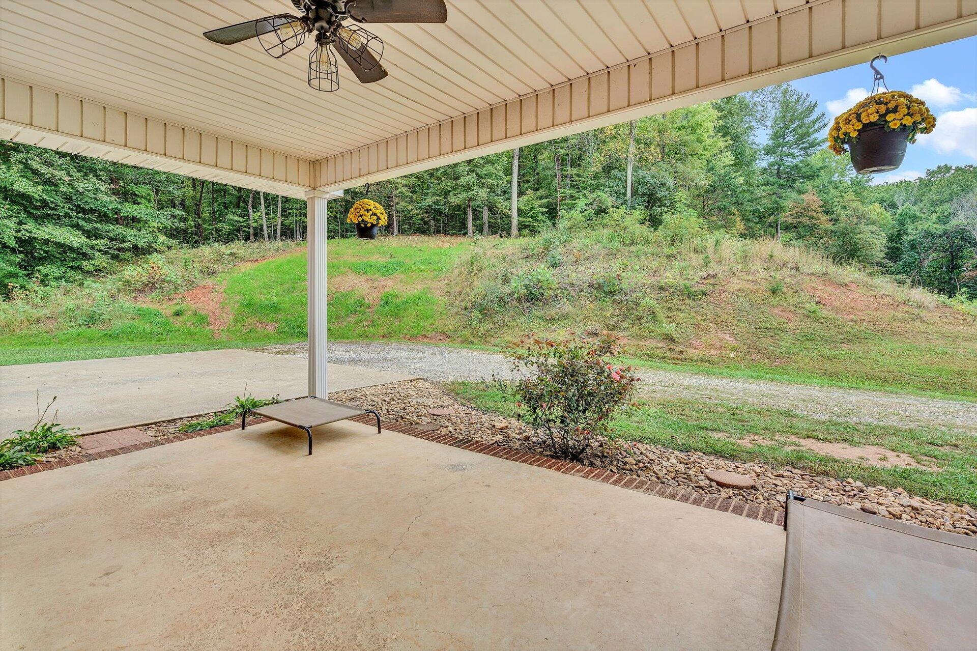 415 Eton Road Hardy, VA 24101 - Photo 22 of 44 a view of a porch with a table and chairs under an umbrella