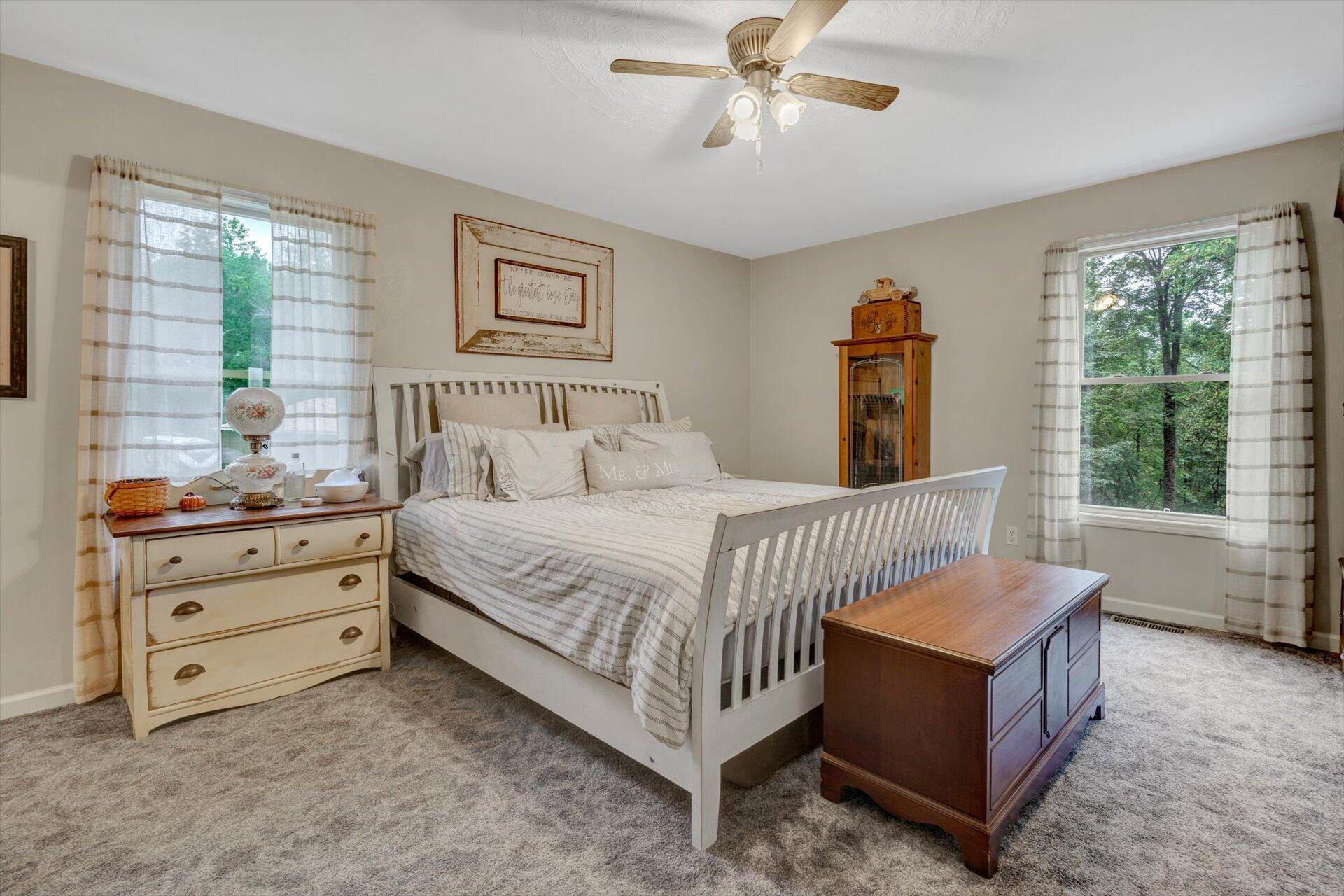 415 Eton Road Hardy, VA 24101 - Photo 27 of 44 a bedroom with a bed and a chandelier fan