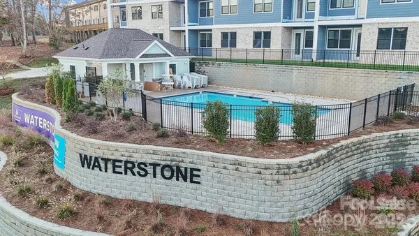 a front view of a house with a yard and lake view