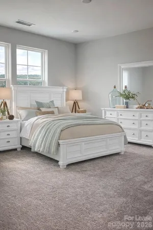 a bedroom with a white bed and a dresser