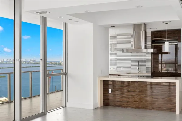 a view of kitchen with stainless steel appliances granite countertop cabinets and glass door