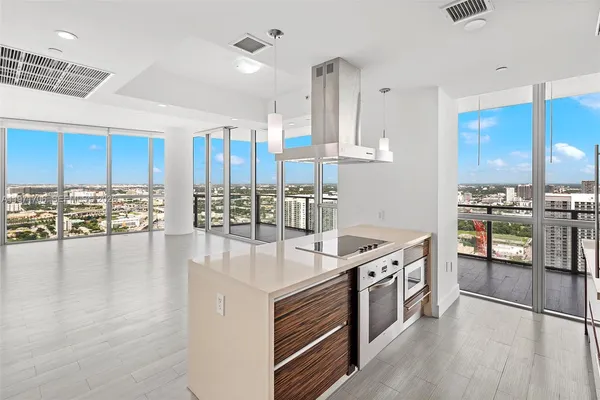 a kitchen with stainless steel appliances granite countertop a stove and a wooden cabinets