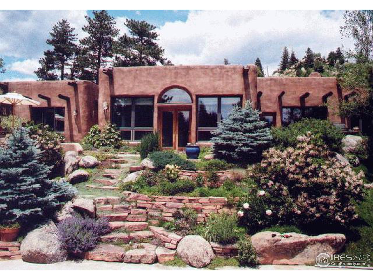 136 Old Post Office Road Boulder, CO 80302 - Photo 1 of 11 a view of a house with a yard and garden