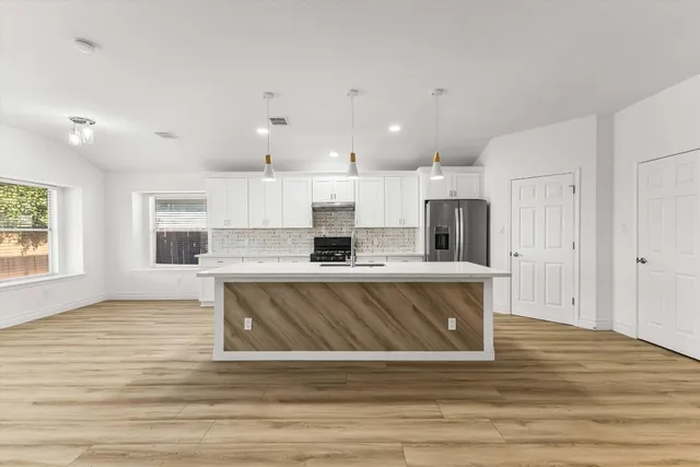 a kitchen with a stove and a sink