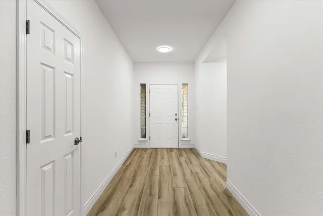 a view of a room with wooden floor