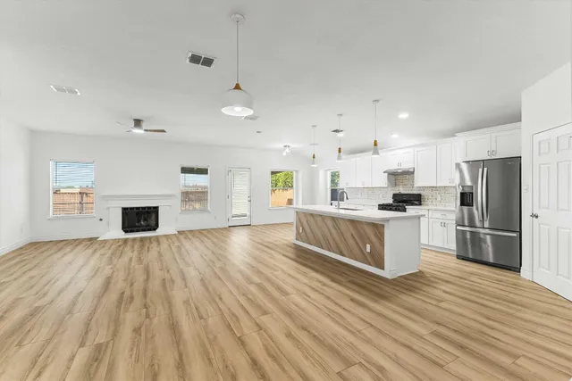 a view of a house with pool plants and large tree