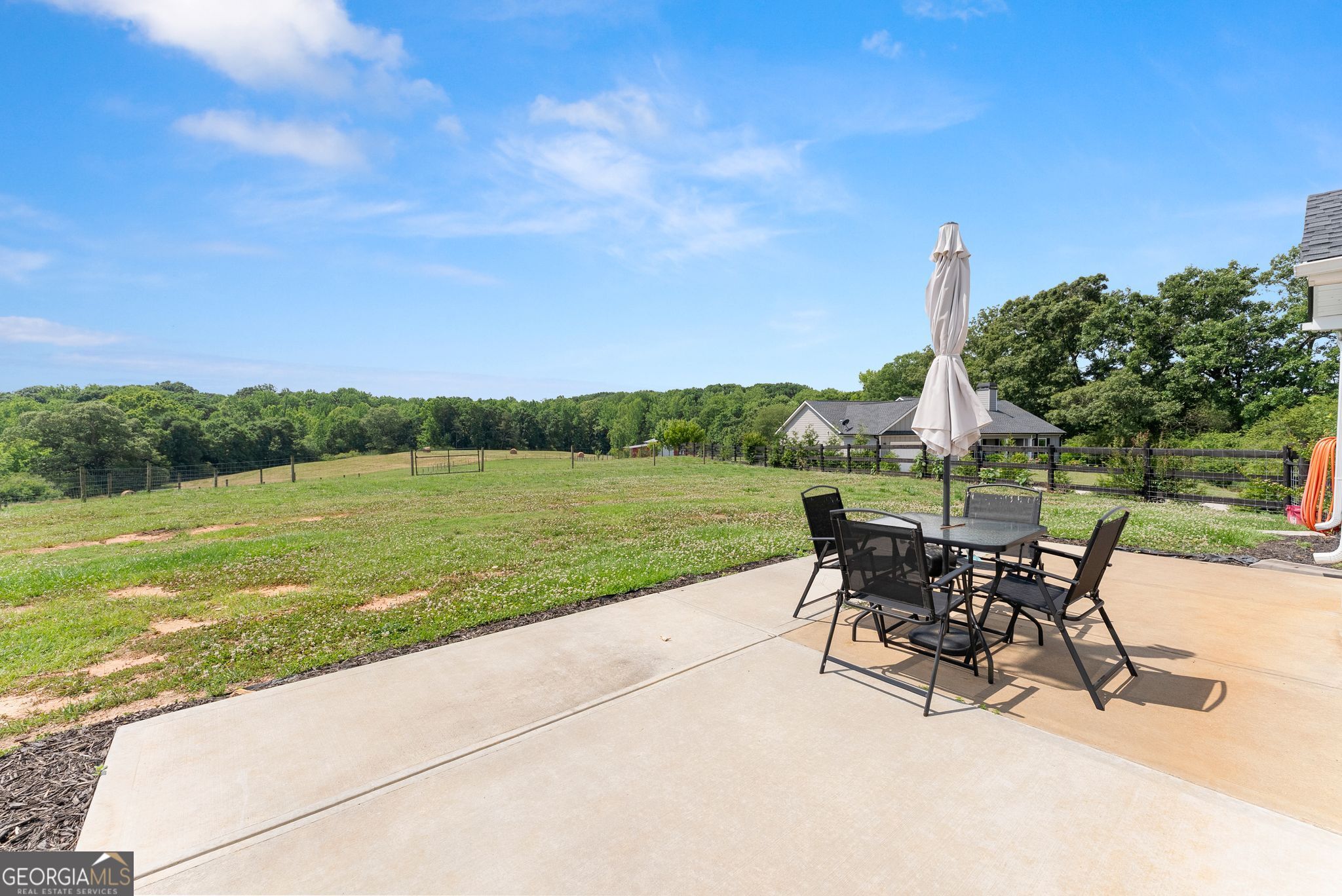 810 Anderson Thomas Road Martin, GA 30557 - Photo 28 of 40 a view of a lake with table and chairs under an umbrella