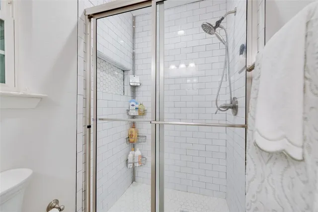 a bathroom with a granite countertop toilet sink and mirror