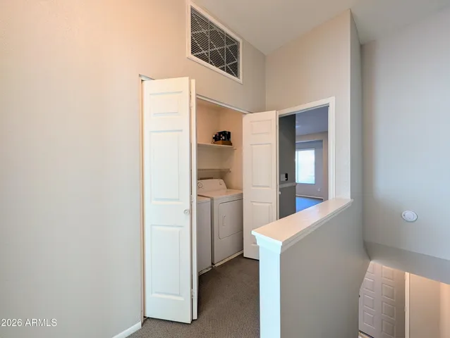 a view of hallway with washer and dryer