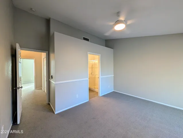 an empty room with windows and entrance