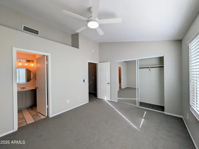 an empty room with a bathroom and a sink