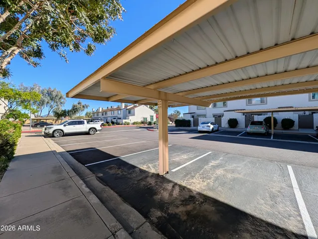 a view of a cars park in front of a building