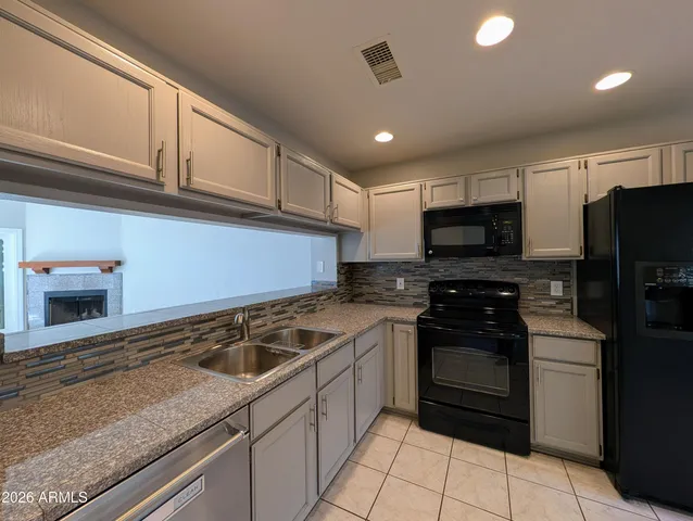 a kitchen with a sink stove and microwave