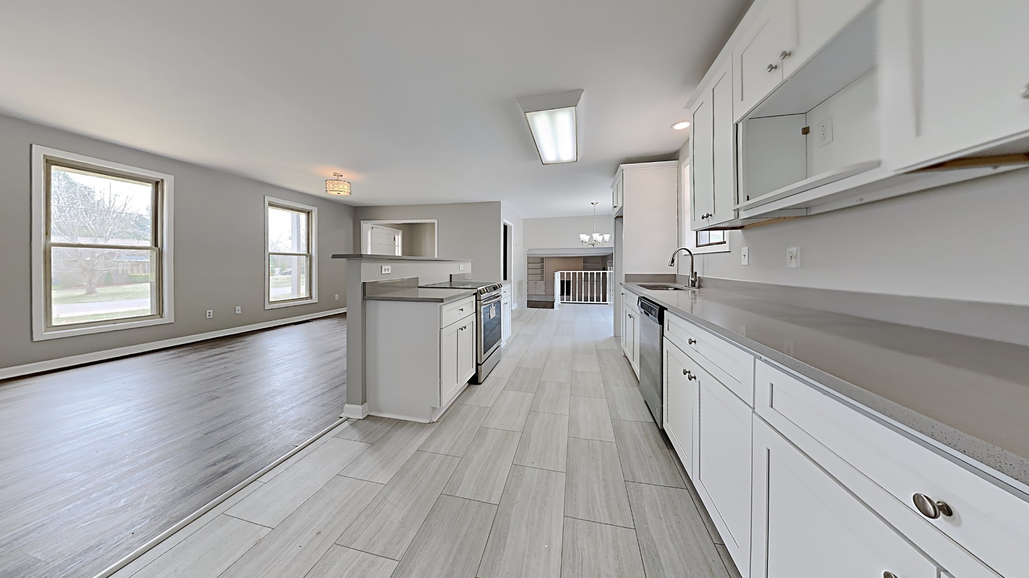 3549 Forest Park Road Springfield, TN 37172 - Photo 6 of 27 a kitchen with granite countertop a stove oven a sink dishwasher and white cabinets with wooden floor