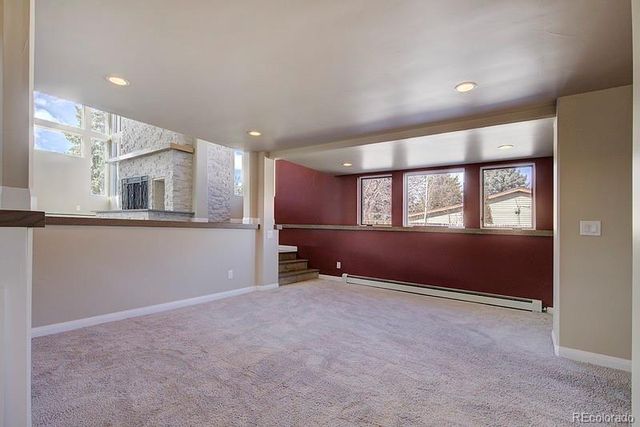 an empty room with a empty space and windows