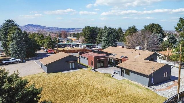 a view of a house with a swimming pool and sitting area