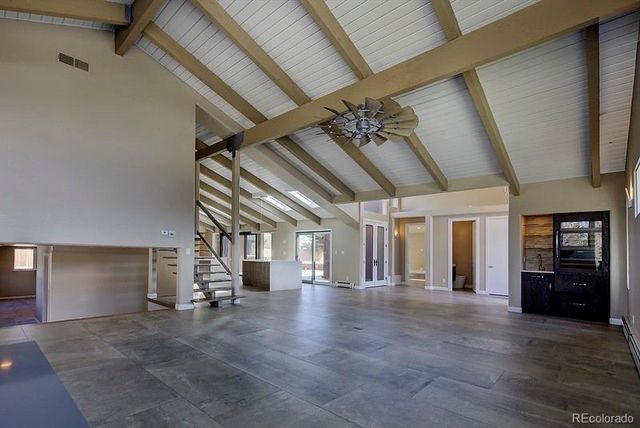 a view of empty room with wooden floor
