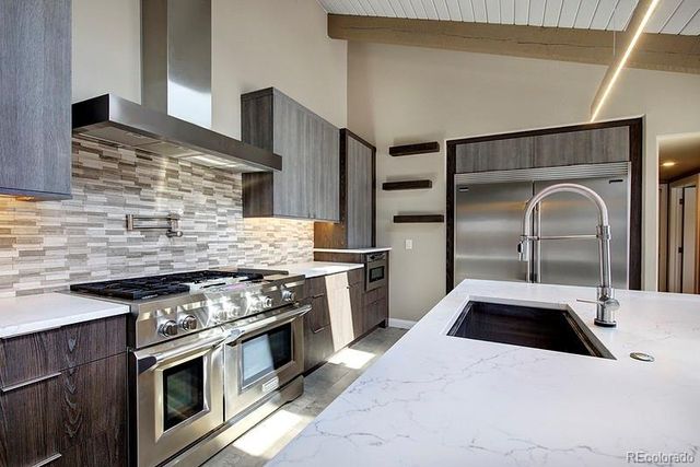 a kitchen with stainless steel appliances granite countertop a stove and a sink