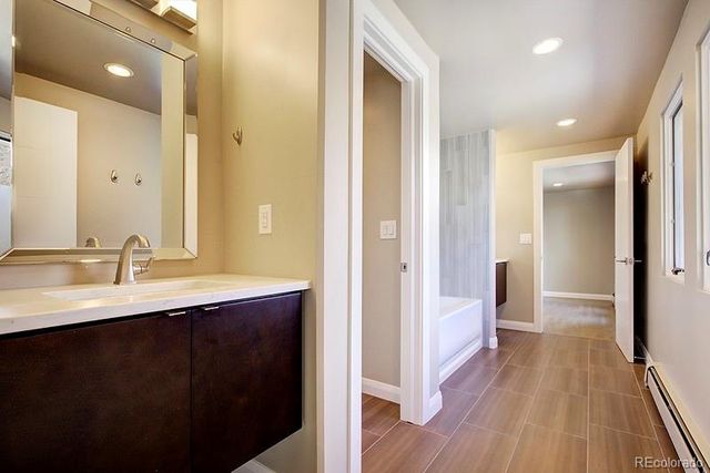 a en suite bathroom with a sink mirror and shower