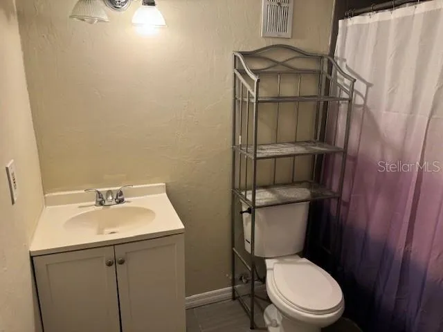 a white toilet sitting next to a bathroom sink