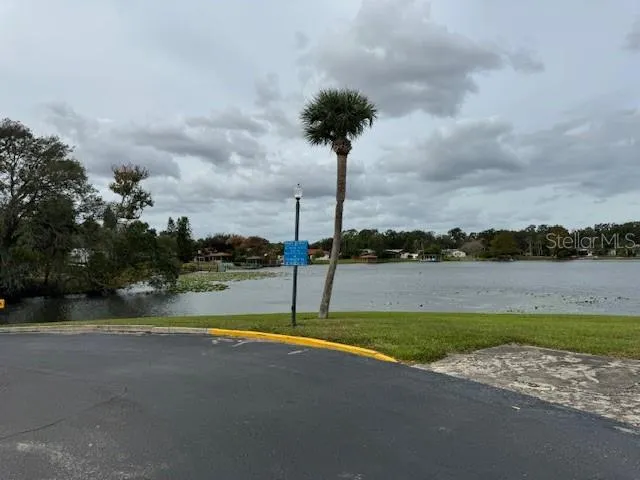 a view of a house with a yard and basketball court