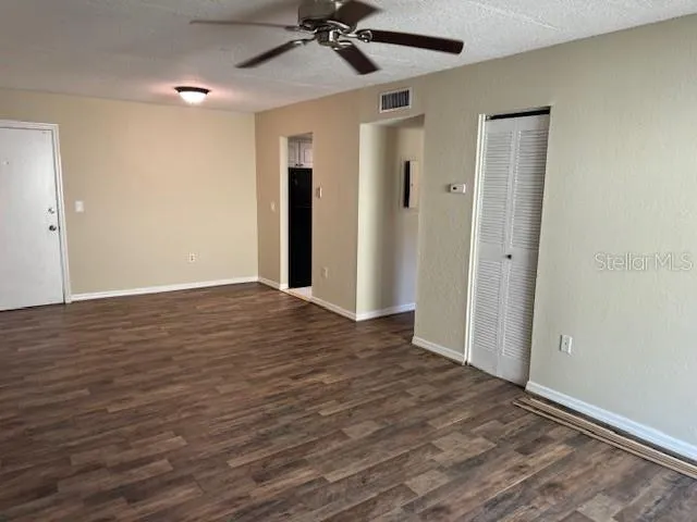 a view of an empty room and wooden floor