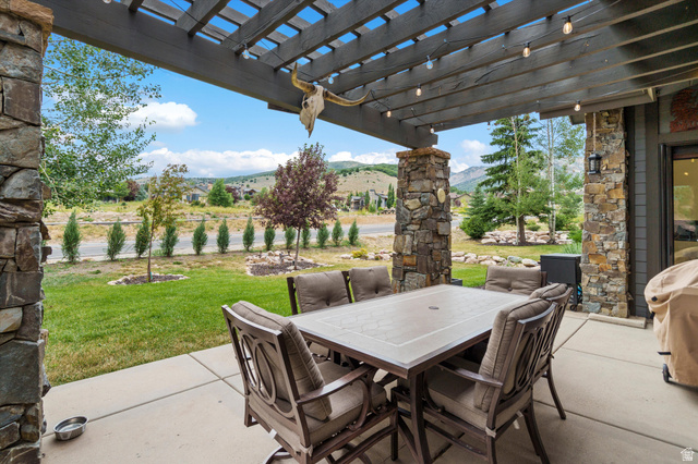 4892 Eagle Rdg Drive Eden, UT 84310 - Photo 25 of 39 Expansive covered patio featuring a wood pergola and stone columns