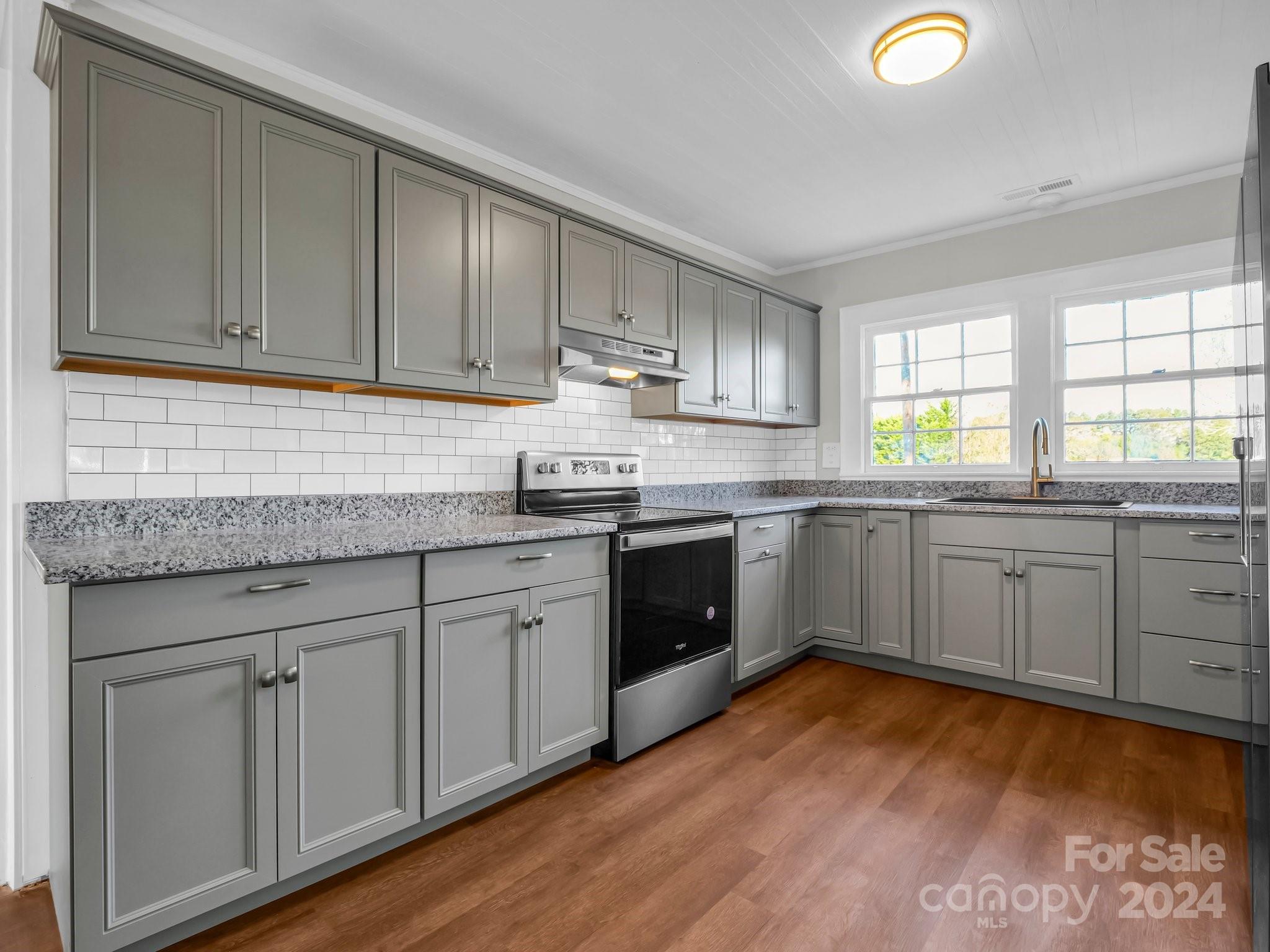 574 Cat Square Road Lincolnton, NC 28092 - Photo 13 of 48 a kitchen with stainless steel appliances granite countertop a sink cabinets and wooden floors