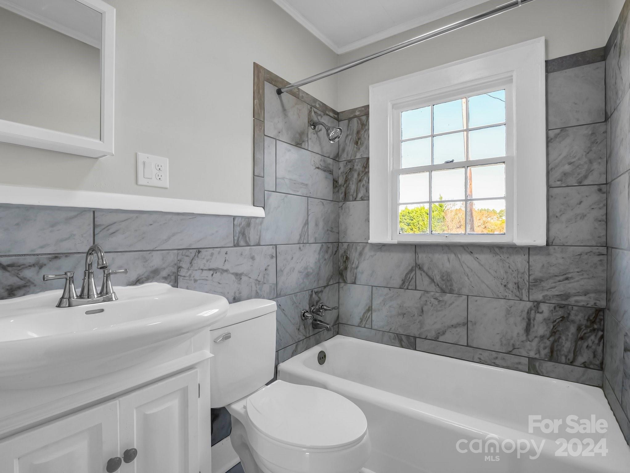 574 Cat Square Road Lincolnton, NC 28092 - Photo 27 of 48 a white bath tub sitting next to a white sink and a toilet