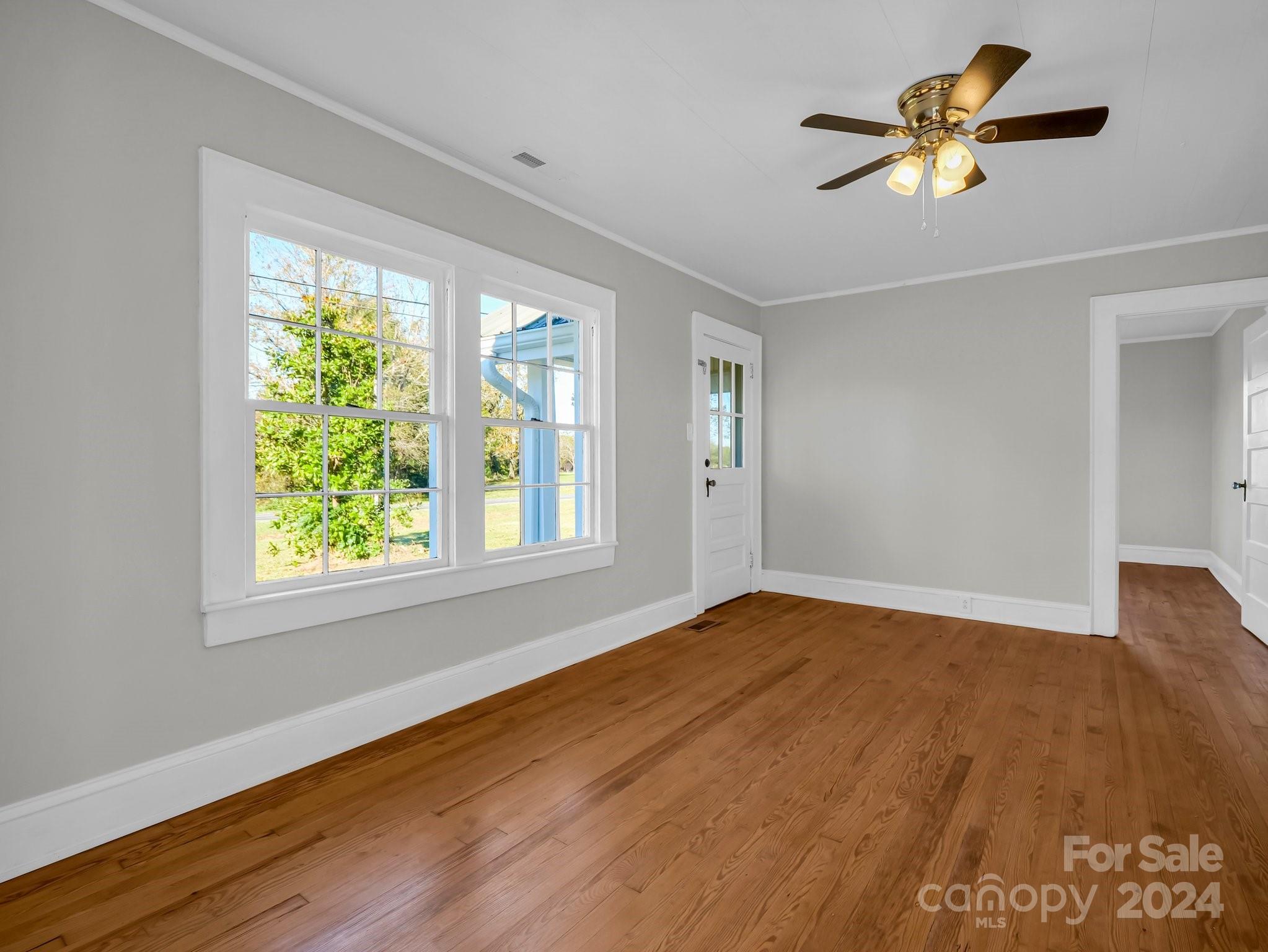 574 Cat Square Road Lincolnton, NC 28092 - Photo 8 of 48 a view of empty room with wooden floor and fan