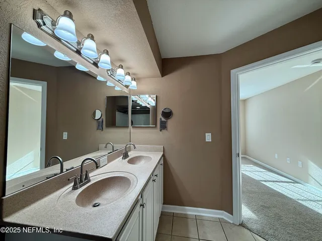 a bathroom with a sink vanity granite and toilet