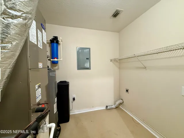 a front view of a house with a tree