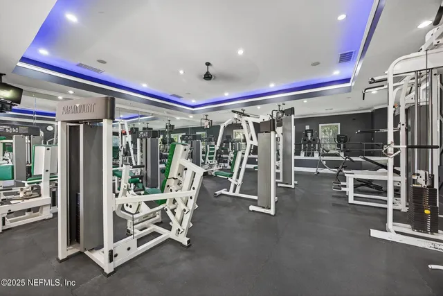a view of a house with a yard and potted plants
