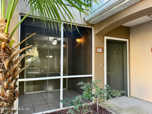 a kitchen with stainless steel appliances granite countertop a refrigerator a sink dishwasher a stove and a dining table with wooden floor