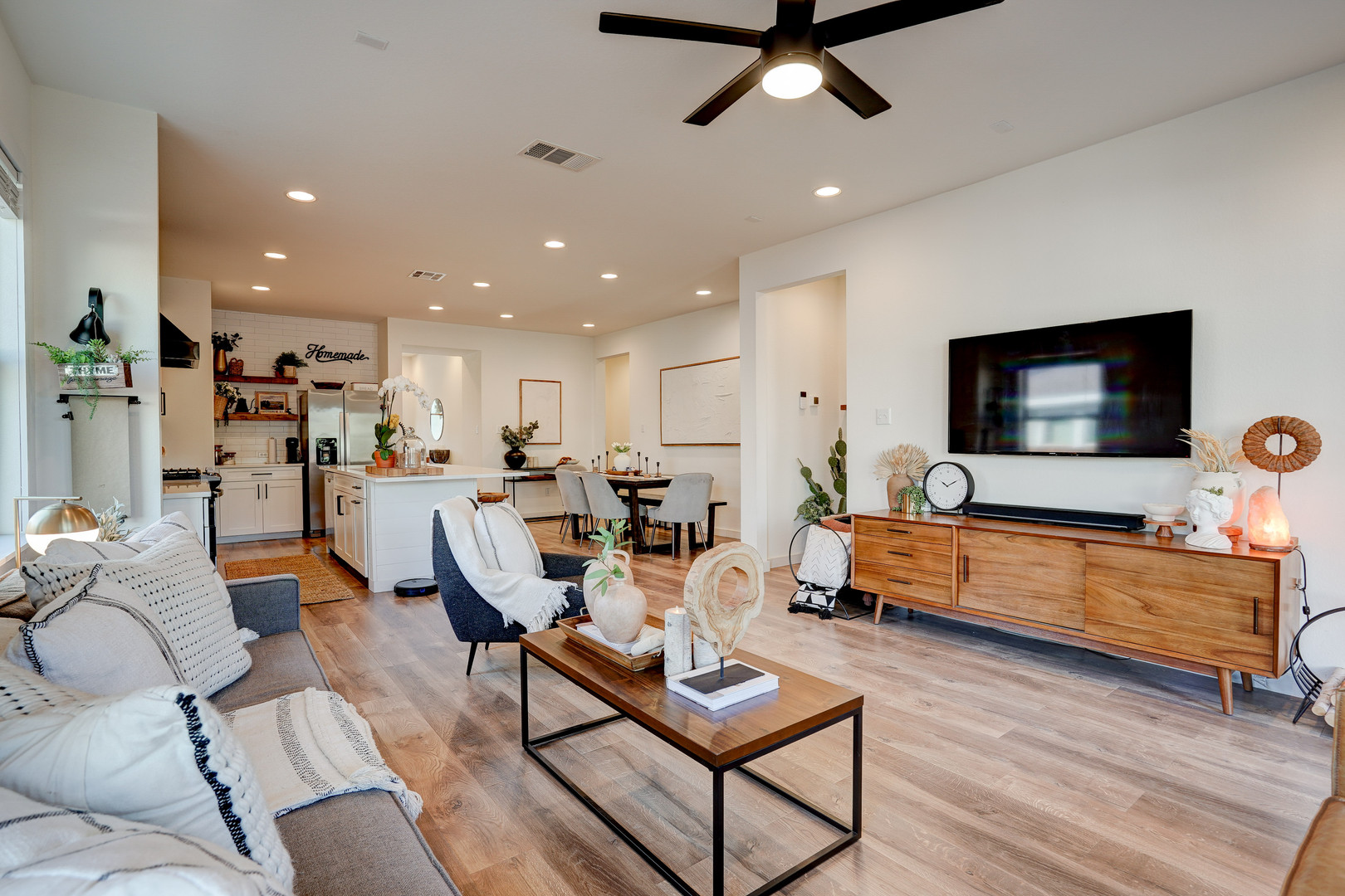 2240 Ringstaff Road Leander, TX 78641 - Photo 10 of 25 Open-concept living space featuring wood-finish flooring, recessed lighting, a ceiling fan with integrated light, and white walls
