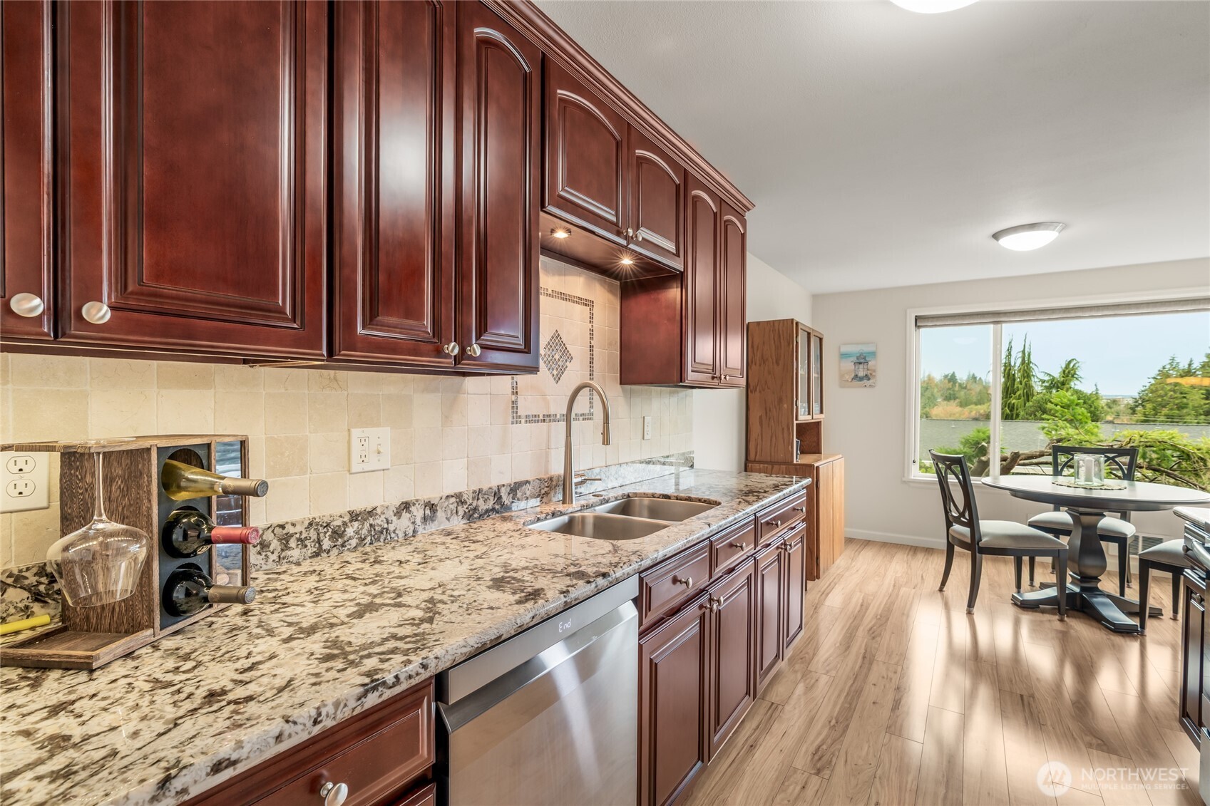 1020 5th Avenue South, Unit 8 Edmonds, WA 98020 - Photo 12 of 28 a kitchen with granite countertop a sink stove and cabinets