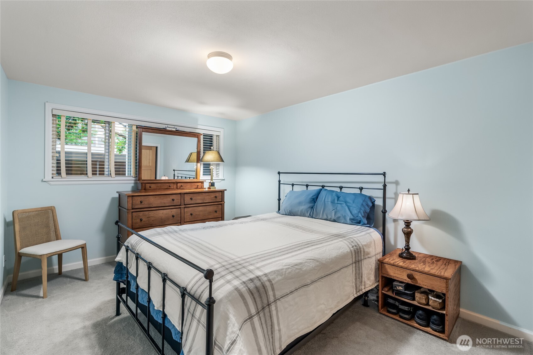 1020 5th Avenue South, Unit 8 Edmonds, WA 98020 - Photo 18 of 28 a bedroom with a bed and a table in it