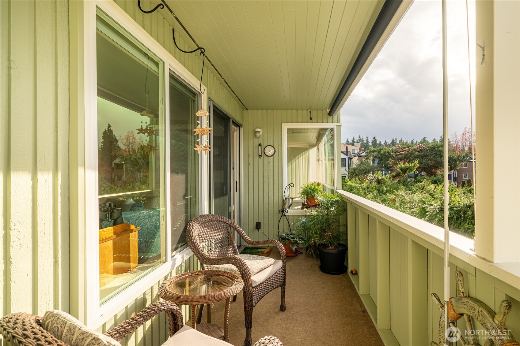 1020 5th Avenue South, Unit 8 Edmonds, WA 98020 - Photo 2 of 28 a view of a balcony with chair and a glass door