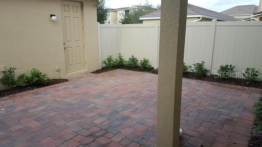 7652 Ripplepointe Way Windermere, FL 34786 - Photo 16 of 21 a view of a house with a backyard and potted plants