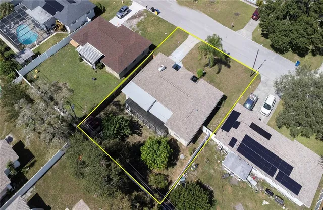 an aerial view of a house with a yard